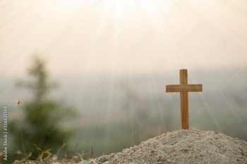 Religious concepts. Christian wooden cross on a background with dramatic lighting,  Jesus Christ cross, Easter, resurrection concept. Christianity, Religion copyspace background.