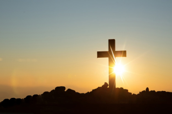 Resurrection concept: crucifixion of jesus christ cross at sunset