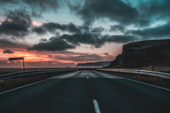 road under dark clouds during sunset road under dark clouds during sunset