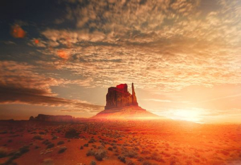 rock formation near hill under white clouds during sunset rock formation near hill under white clouds during sunset