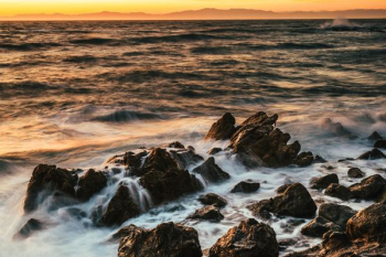 rock on beach under golden hour rock on beach under golden hour