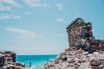 Rocky Terrain Near Sea Under Blue Skies Rocky Terrain Near Sea Under Blue Skies