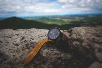 round black analog watch on stone round black analog watch on stone