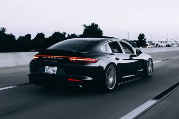 running black Porsche sedan running black Porsche sedan