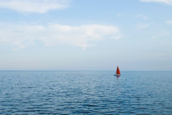 sailboat on body of water during daytime sailboat on body of water during daytime