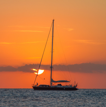 Sailboat on Body of Water during Sunset Sailboat on Body of Water during Sunset