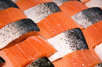Salmon fillets for sale at a fish market displayed with a patchwork effect