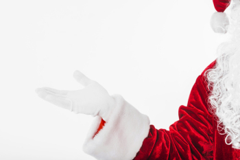Santa Claus in red showing something with hand Santa Claus in red showing something with hand
