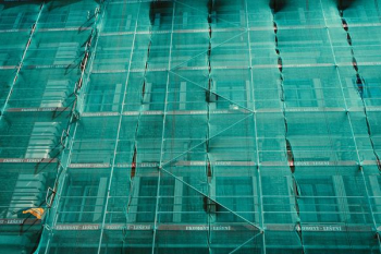 scaffolding covered by green net scaffolding covered by green net