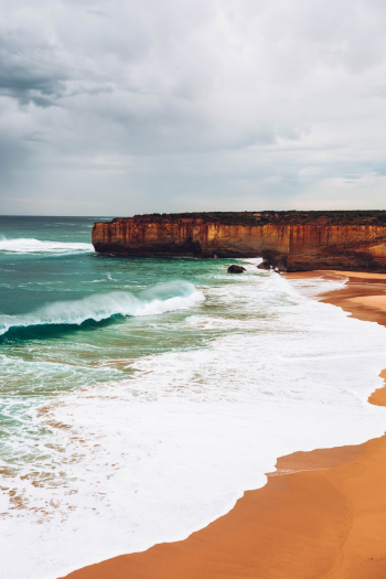 Scenic View Of Beach Under Cloudy Sky Scenic View Of Beach Under Cloudy Sky