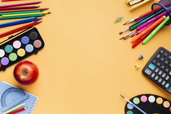 School supplies scattered on yellow table Free Photo