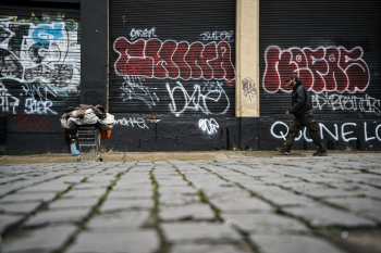 SE Portland street life, all your belongings in a shopping cart.  Constantly on the move in a sea of Graffiti.
