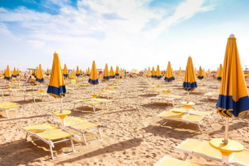 seashore with lounger and patio umbrella seashore with lounger and patio umbrella