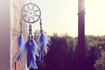 selective focus of hanging blue and black dream catcher selective focus of hanging blue and black dream catcher