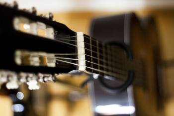 Selective Focus Photo of Black Classical Guitar Selective Focus Photo of Black Classical Guitar