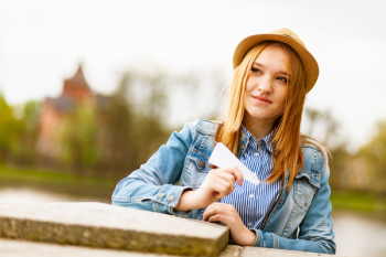 Selective Focus Photo of Woman Smiling Holding White Paper Airplane
