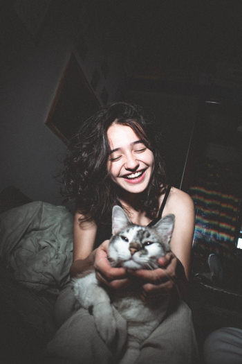 Selective Focus Photography of Smiling Girl Holding Cat Selective Focus Photography of Smiling Girl Holding Cat
