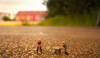 Selective Focus Photography of Two Men Builder Figurines Selective Focus Photography of Two Men Builder Figurines