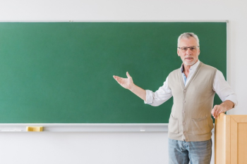 Senior professor pointing at blackboard Free Photo Senior professor pointing at blackboard Free Photo