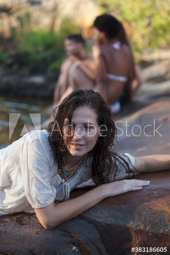 Sensual young woman relaxing on wet rocks Sensual young woman relaxing on wet rocks