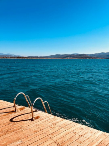 Serene Lakeside View with Wooden Deck Serene Lakeside View with Wooden Deck