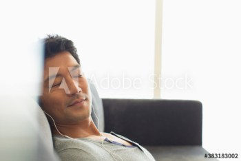 Serene man listening to music with headphones Serene man listening to music with headphones