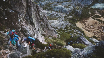 several mountain climbers on cliff of rock mountain at daytime several mountain climbers on cliff of rock mountain at daytime