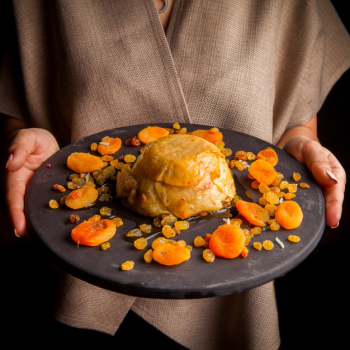 Shah pilaf with dried fruits and human hand in round plate Free Photo Shah pilaf with dried fruits and human hand in round plate Free Photo