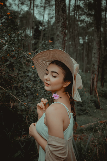 Shallow Focus Photo of Woman Holding a Flower Shallow Focus Photo of Woman Holding a Flower