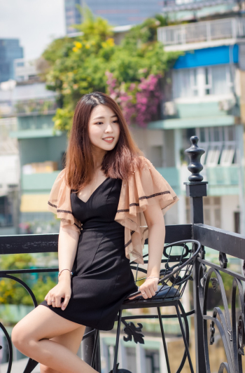 Shallow Focus Photo of Woman in Black Dress Sitting on Bar Chair Shallow Focus Photo of Woman in Black Dress Sitting on Bar Chair