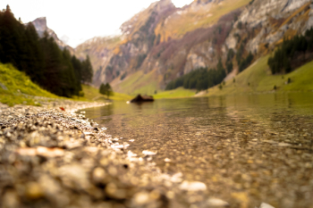 Shallow Focus Photography of Body of Water Near Mountain Shallow Focus Photography of Body of Water Near Mountain