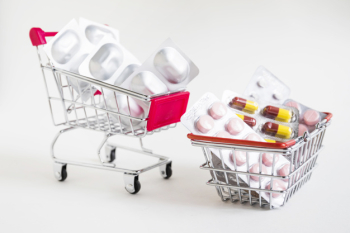Shopping carts with blister medicines on white background Shopping carts with blister medicines on white background