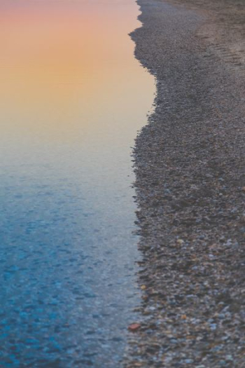 shore beside ocean during sunset shore beside ocean during sunset