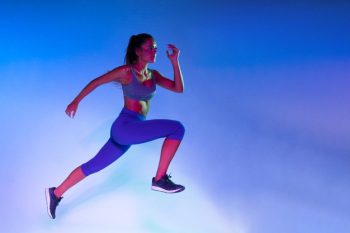 Side view of athlete training with blue background Free Photo Side view of athlete training with blue background Free Photo