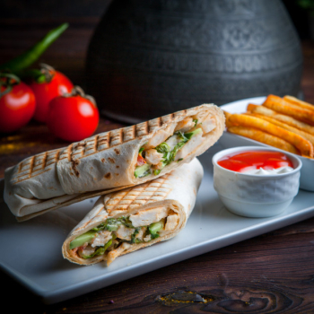 Side view shawarma pita roll with chicken and fried potatoes Free Photo Side view shawarma pita roll with chicken and fried potatoes Free Photo
