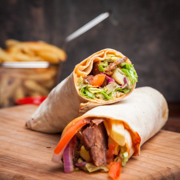 Side view shawarma with fried potatoes in board cookware Free Photo Side view shawarma with fried potatoes in board cookware Free Photo