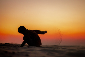 Silhouette of a Child Playing on Sands Silhouette of a Child Playing on Sands