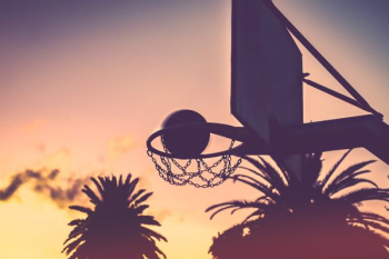 silhouette of basketball hoop and basketball during orange sunet silhouette of basketball hoop and basketball during orange sunet