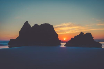 silhouette of island during sunset silhouette of island during sunset