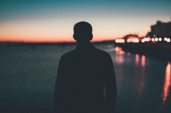 silhouette of man front of sea silhouette of man front of sea