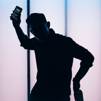 silhouette of man holding smartphone silhouette of man holding smartphone