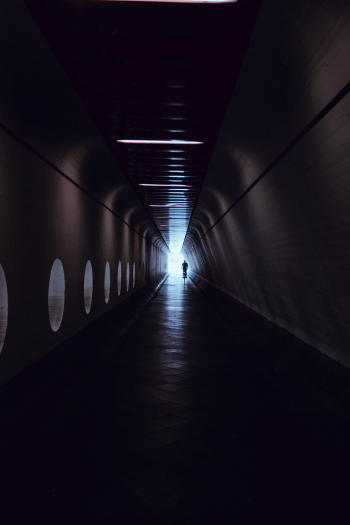 Silhouette of Man Inside a Dark Passage Silhouette of Man Inside a Dark Passage