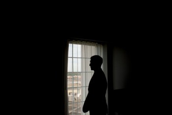 Silhouette of Man Standing in Front of Window Silhouette of Man Standing in Front of Window