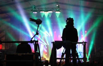 silhouette of man standing on stage silhouette of man standing on stage
