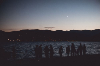 silhouette of people on beach during golden hour silhouette of people on beach during golden hour