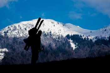 silhouette of person climbing mountain during daytime silhouette of person climbing mountain during daytime