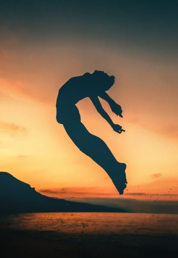 silhouette of person jumping on seashore silhouette of person jumping on seashore