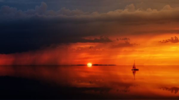 silhouette of sailboat on body of water silhouette of sailboat on body of water