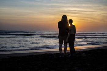 Silhouette Photo Of People Standing On Seaside