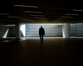 silhouette photo of person walking inside dark room silhouette photo of person walking inside dark room